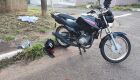 Motocicleta da vítima e ao fundo, pano que serviu para cobrir o corpo