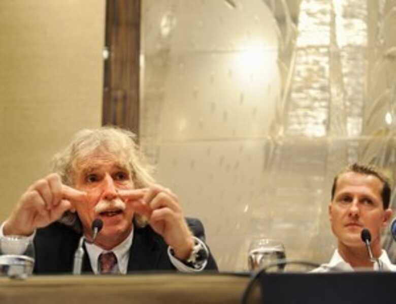 Johannes Peil ao lado de Schumacher em coletiva após o acidente de 2009. (Foto: Getty Images)