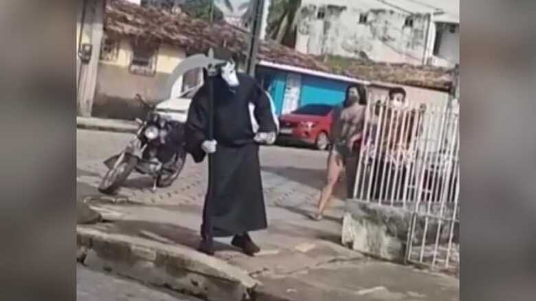 Homem fantasiado de 'morte' caminha pelas ruas de Camet&aacute;, no Par&aacute;