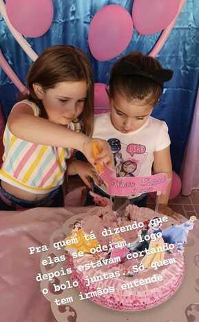 Maria Eduarda e Maria Antonia dividindo o bolo